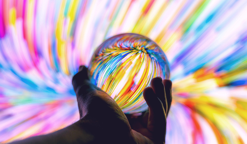 Holding-a-crystal-ball-through-colorful-background-at-night-insight