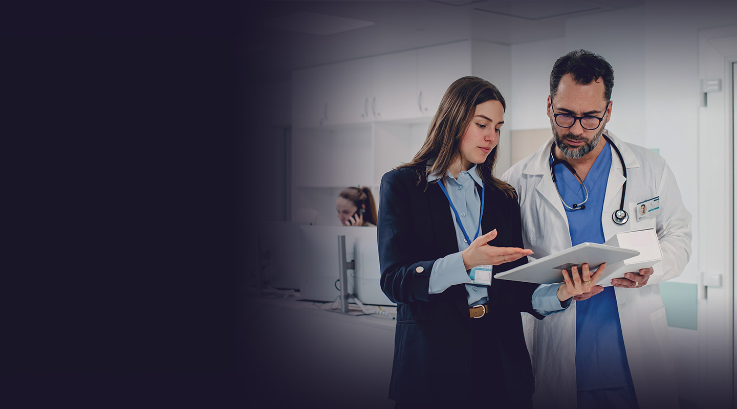 Doctor-talking-with-female-medical-sales-representative-homehero