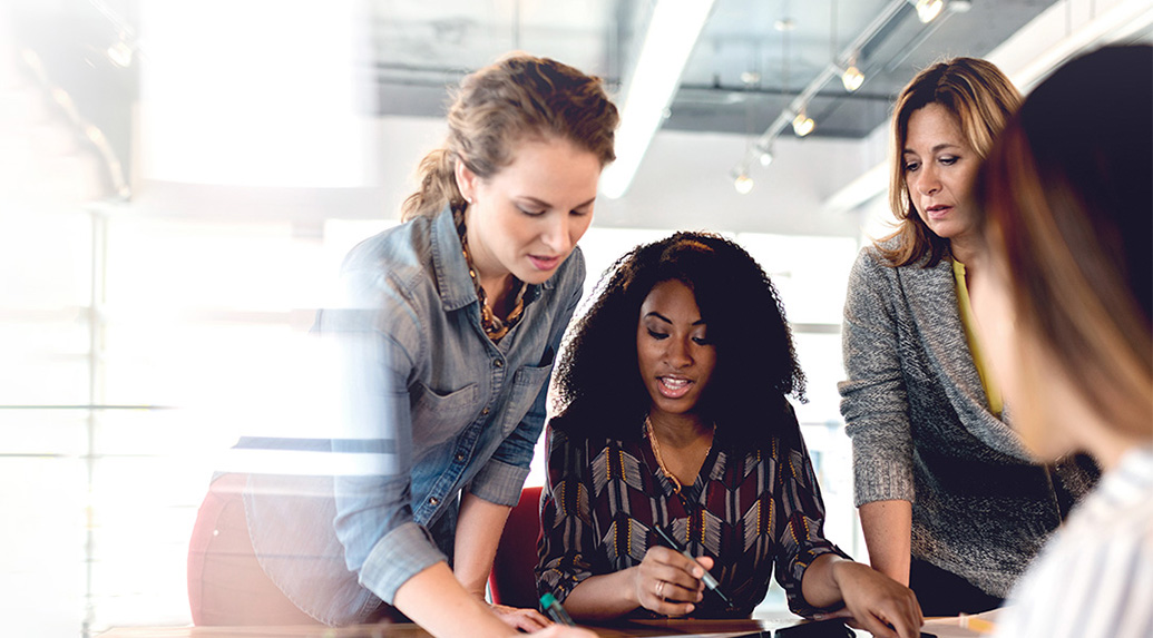 Businesswomen-using-digital-tablet-and-discussing-project-in-office-insight