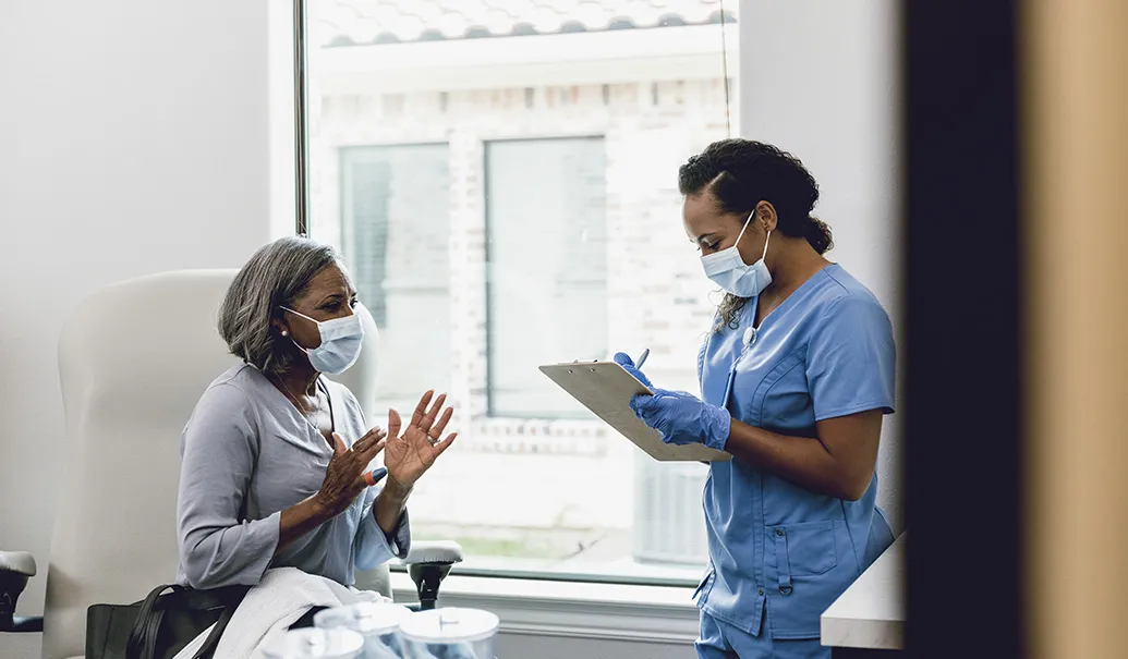 Concerned-patient-talking-with-nurse