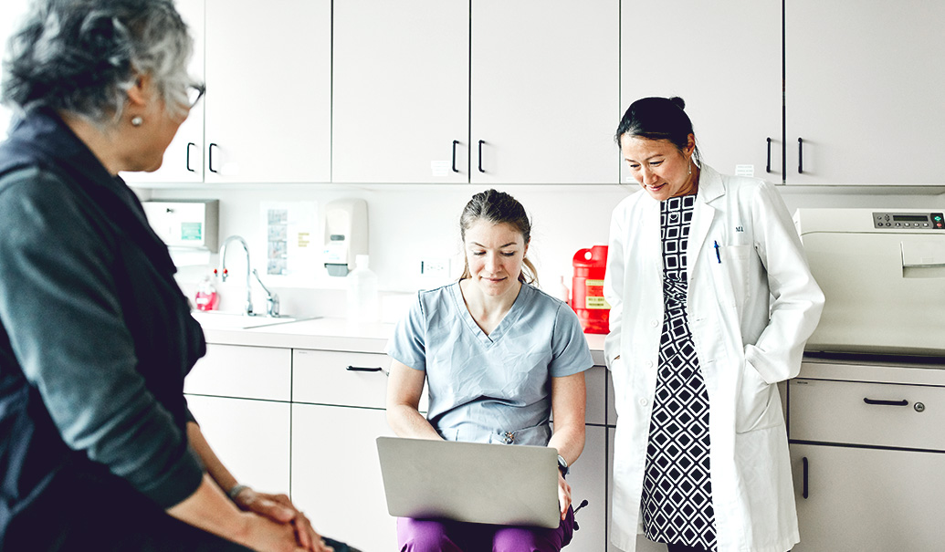 Doctor and nurse looking at patient data