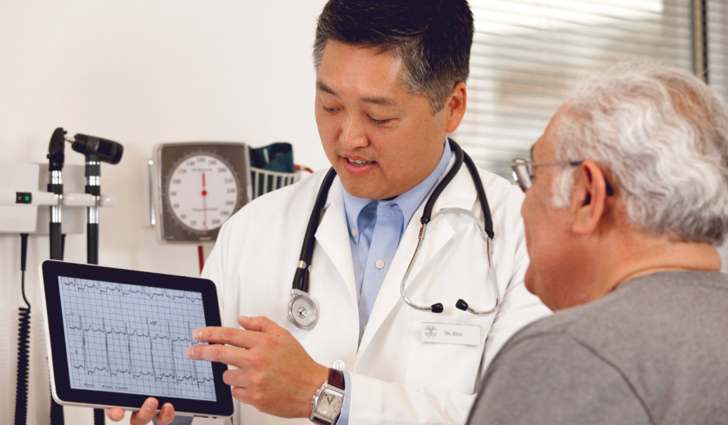 Doctor showing patient results on a digital tablet