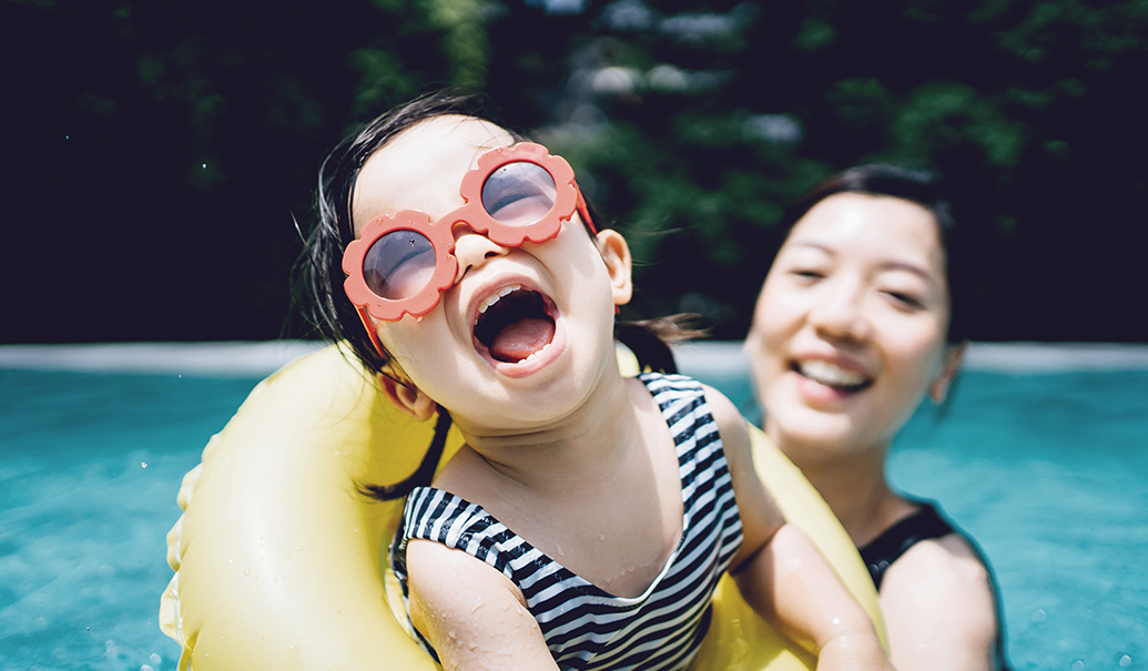 Happy-Asian-toddler-girl-with-sunglasses-smiling-joyfully-insight