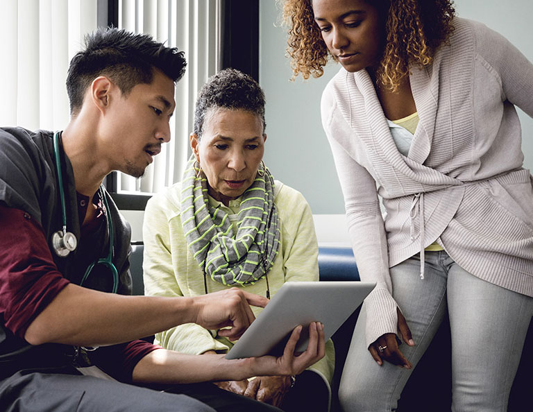Male-nurse-consulting-with-senior-female-patient