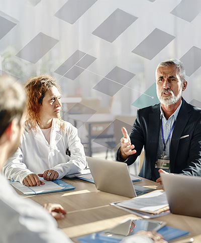 Senior-businessman-talking-to-medical-experts-on-a-meeting-in-hospital-feature-image