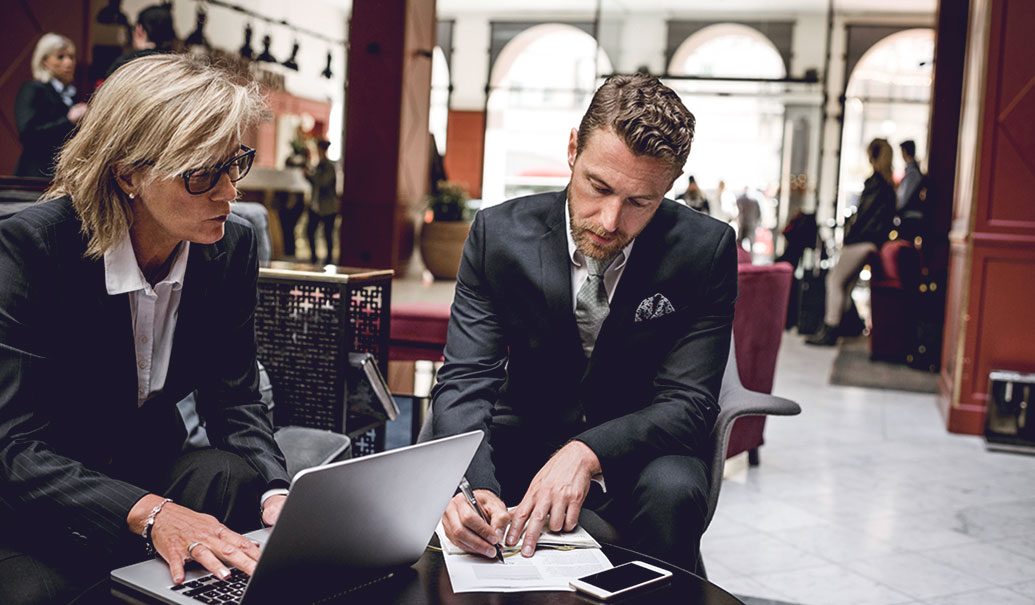 Two business people meeting in hotel lobby