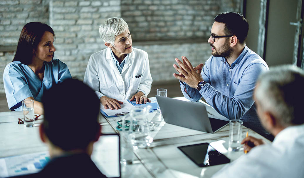 Young-businessman-having-a-meeting-with-medical-experts-in-office